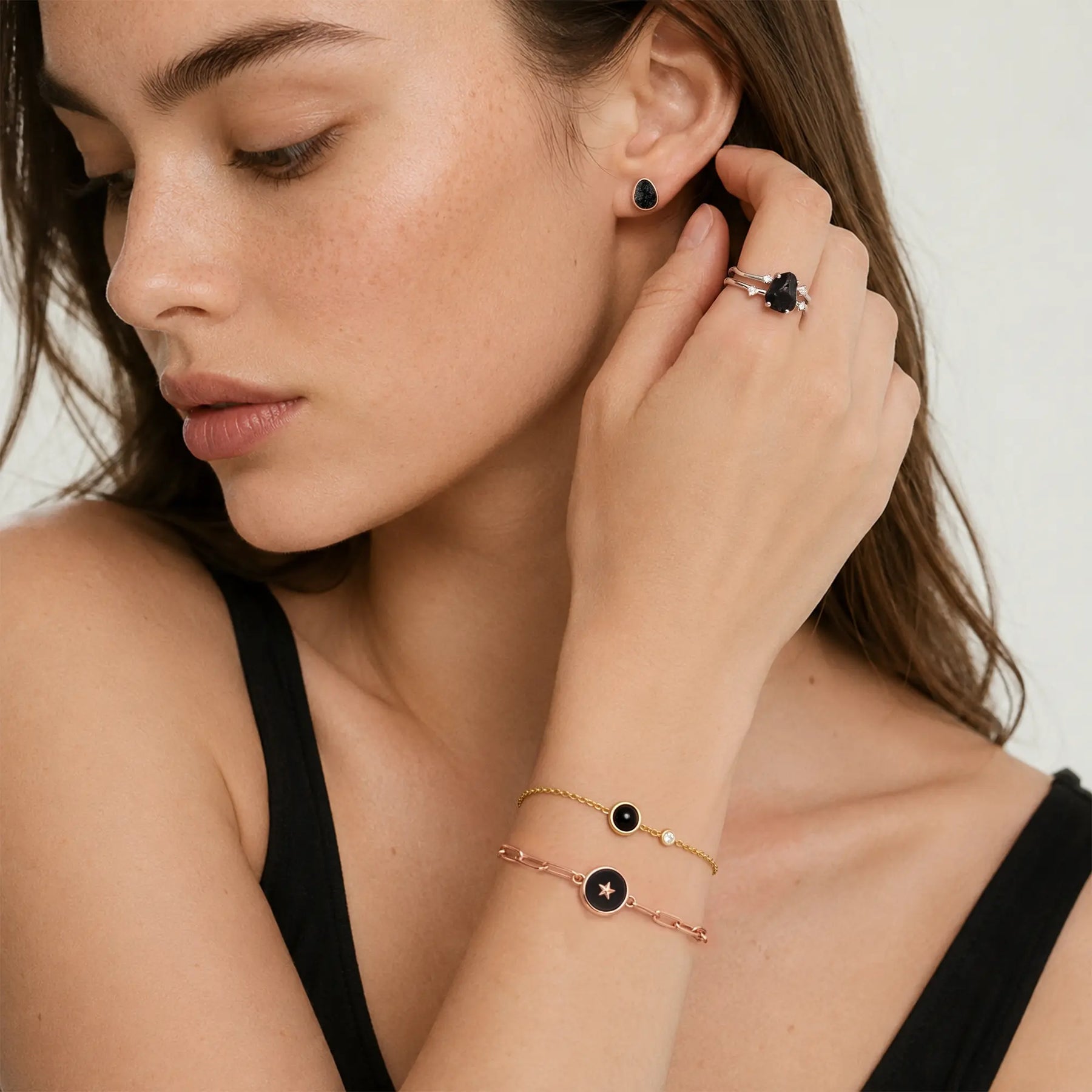 Model Wearing Round Black Onyx Spinner Bracelet with Layered Jewelry